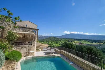 an outdoor swimming pool with a view of the mountains at Maison Ventoux in Crillon-le-Brave