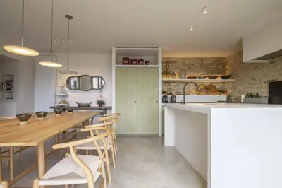 a kitchen and dining room with a table and chairs at Maison Ventoux in Crillon-le-Brave