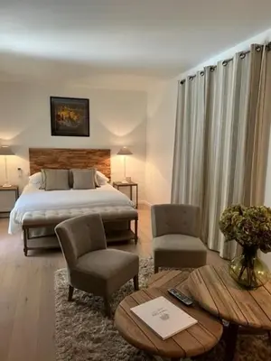 a bedroom with a bed and a table and chairs at FOUR DE CONY in Saumane-de-Vaucluse