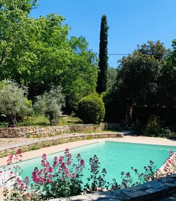 a swimming pool in a garden with flowers at La Farigoule - Sainte-Victoire - Vue exceptionnelle sur Aix-en-Provence in Aix-en-Provence
