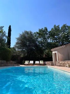 a swimming pool with two lounge chairs next to it at La Farigoule - Sainte-Victoire - Vue exceptionnelle sur Aix-en-Provence in Aix-en-Provence