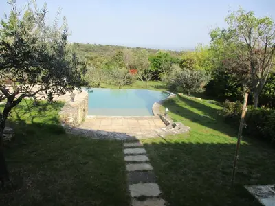 a swimming pool in the middle of a yard at Gîte du Jardin des Espuys in Venasque