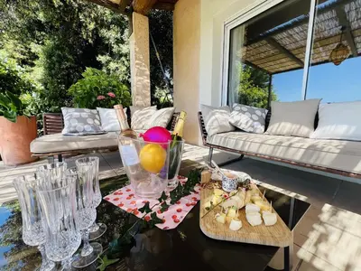a outdoor grill with a bowl of vegetables on a patio at Maison Beally in Eyragues