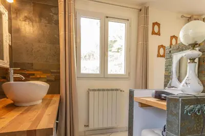 a bedroom with a large bed and a television at Maison Beally in Eyragues