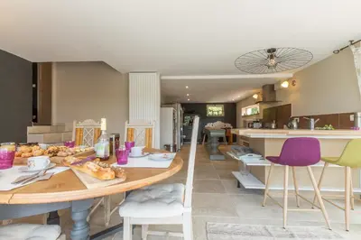 a kitchen and dining room with a table and chairs at Maison Beally in Eyragues