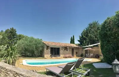 a villa with a swimming pool in front of a house at Le Mas les Pléiades - Private pool - Gordes in Gordes