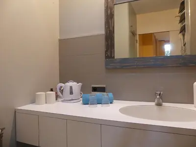 a bathroom counter with a sink and a mirror at les 3 saisons in Cucuron