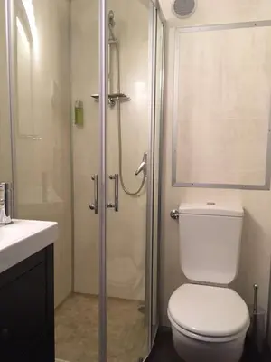 a bathroom with a shower and a toilet and a sink at Brit Hotel Salon de Provence in Salon-de-Provence