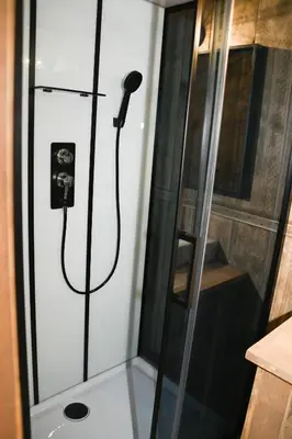 a kitchen with a refrigerator and a wooden floor at Camping le Colorado in Rustrel