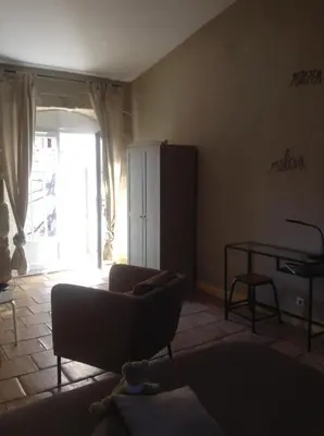 a living room with a couch and a table at La demeure in Eyguières