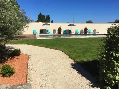 a house with chairs and umbrellas in a yard at Large family home with private pool in Vignères, 10 sleeps. in Cavaillon
