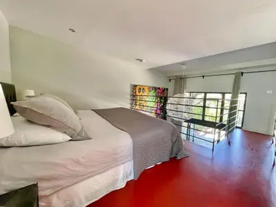 a bedroom with a white bed and a window at Loft 52 in Aix-en-Provence