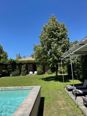 a house with a swimming pool and an umbrella at Loft 52 in Aix-en-Provence