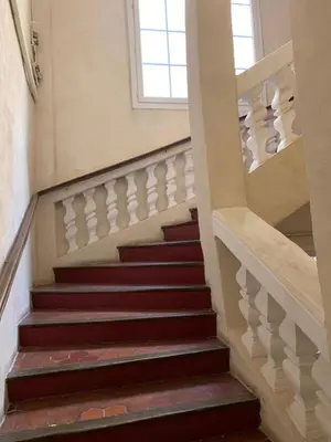 a set of stairs in a building with a window at L'Appart 6 in Aix-en-Provence