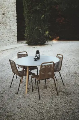 a table with two chairs and a wine glass on it at Domaine de Carraire in Aix-en-Provence