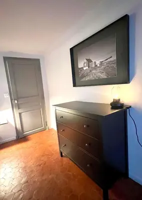 a bedroom with a dresser and a painting on the wall at Maison Alberta in Aix-en-Provence