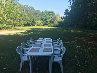 a long table with chairs sitting in a field at La Jacquemarie in Monteux