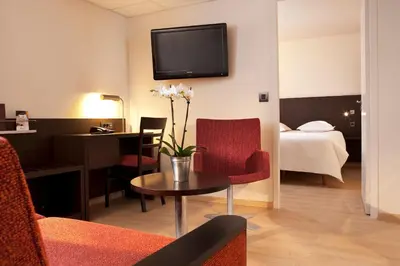 a living room with a room with a hotel room at Escale Oceania Aix-en-Provence in Aix-en-Provence