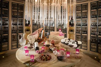 a room with a table with wine bottles and glasses at Villa Gallici Hôtel & Spa in Aix-en-Provence