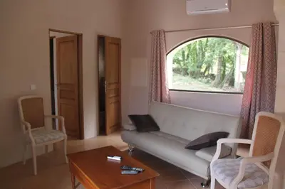 a living room with a couch and a window at Le Hameau Fleur de Pierres , Chambre , Gite et Table d'Hôtes in Murs