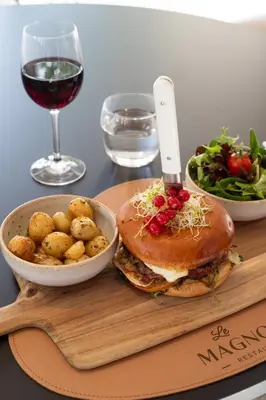 a sandwich and a bowl of potatoes and a glass of wine at Golden Tulip Avignon Le Paradou in Avignon