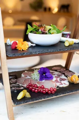 a plate of food on a shelf with a bowl of food at Golden Tulip Avignon Le Paradou in Avignon