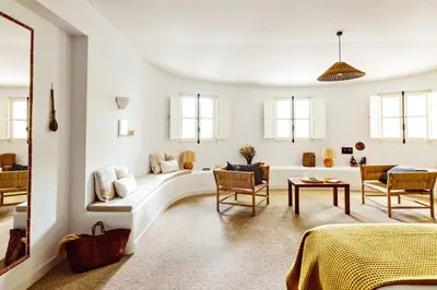 a bedroom with a yellow bed and a window at Le Moulin, Lourmarin, a Beaumier Hotel in Lourmarin
