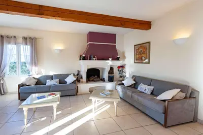 a living room with two couches and a fireplace at Residhotel Golf Grand Avignon in Vedène