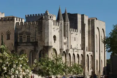 a large stone building with trees in front of it at Residhotel Golf Grand Avignon in Vedène