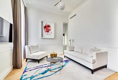 a living room with a white couch and two chairs at Château de la Gaude in Aix-en-Provence