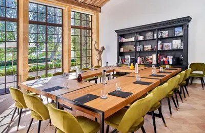 a large dining room with a long table and chairs at Château de la Gaude in Aix-en-Provence