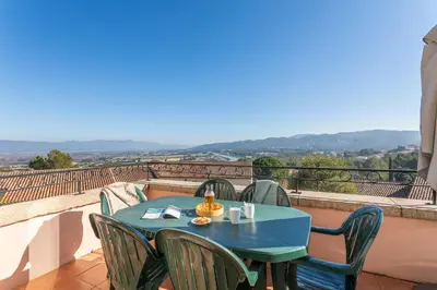 a table and chairs on a balcony with a view at Village Pierre & Vacances Pont Royal en Provence in Mallemort