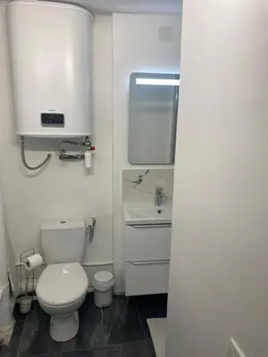 a white bathroom with a toilet and a sink at L'Escapade Aixoise hyper centre historique studios free netfilx wifi romantics apartments historic center in Aix-en-Provence