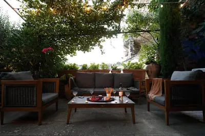 a patio with a couch and two chairs and a table at Le Bonheur in Gordes