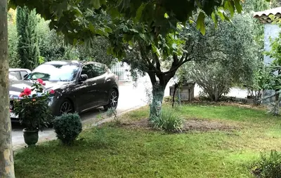 a car parked in a yard next to a tree at Domaine du Castel in Aix-en-Provence