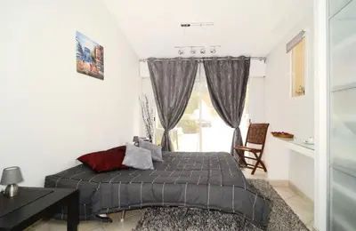 a bedroom with a bed and a desk and a window at Domaine du Castel in Aix-en-Provence
