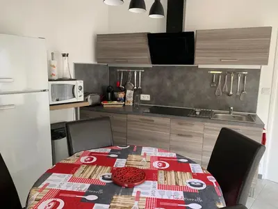 a kitchen with a table with a red plate on it at La Campanette en Luberon -Piscine privée in Cheval-Blanc