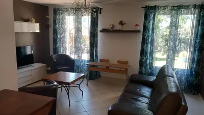 a living room with a couch and a table at Villa - La quiétude de St Antoine - piscine privée in LʼIsle-sur-la-Sorgue