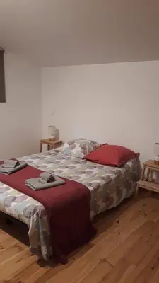 a large bed in a room with a wooden floor at Gîte du Mas Saint-Victor in Bonnieux