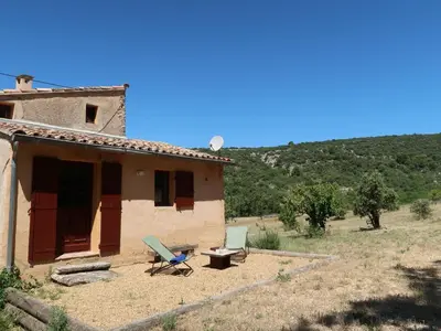 a house with a table and chairs in front of it at Holiday Home Les Huppes by Interhome in Saint-Saturnin-les-Apt