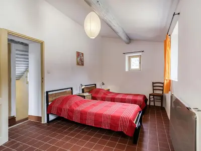 a bedroom with two red beds in a room at Holiday Home Les Huppes by Interhome in Saint-Saturnin-les-Apt