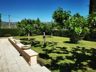 a park with a bench in the grass at Aux portes du Luberon in Cheval-Blanc