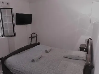 a bedroom with a bed with two slippers on it at Aux portes du Luberon in Cheval-Blanc