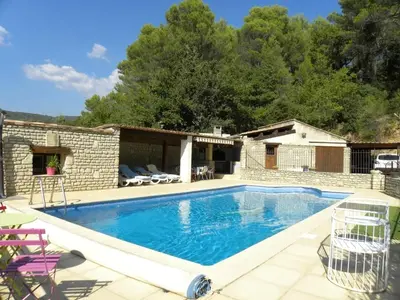 a swimming pool in front of a house at Villa spacieuse à Lioux avec piscine privée et vue montagne in Lioux