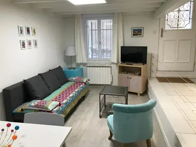a living room with a couch and a tv at Le calme et la tranquilité à 15 minutes d'Avignon in Caumont-sur-Durance