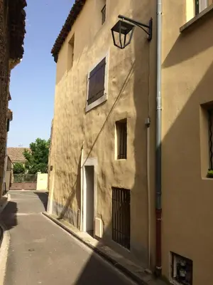 a building with a street light on the side of it at Le calme et la tranquilité à 15 minutes d'Avignon in Caumont-sur-Durance