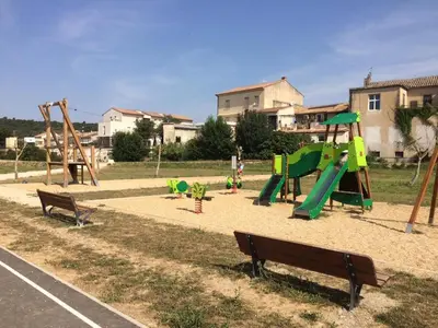 a park with a playground with a slide and benches at Le calme et la tranquilité à 15 minutes d'Avignon in Caumont-sur-Durance