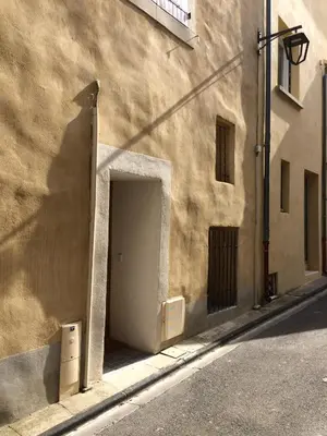 a building with a door on the side of a street at Le calme et la tranquilité à 15 minutes d'Avignon in Caumont-sur-Durance