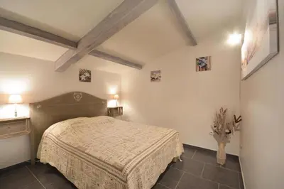 a bedroom with a bed in a room at l 'oliveraie in Gordes