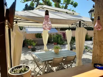 a table with a bottle hanging from a tent at le Mas d'Hubert in LʼIsle-sur-la-Sorgue